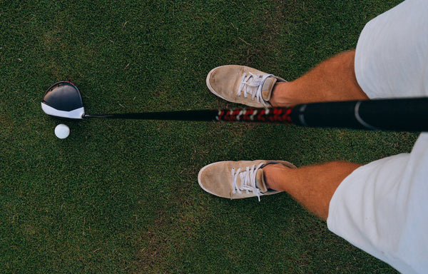 golf club shaft and club head being held by golfer