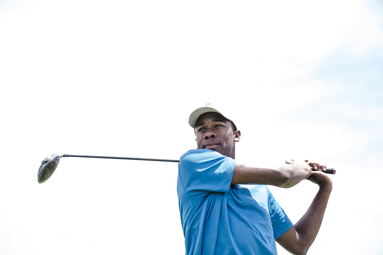 golf player swinging a golf club view from the bottom