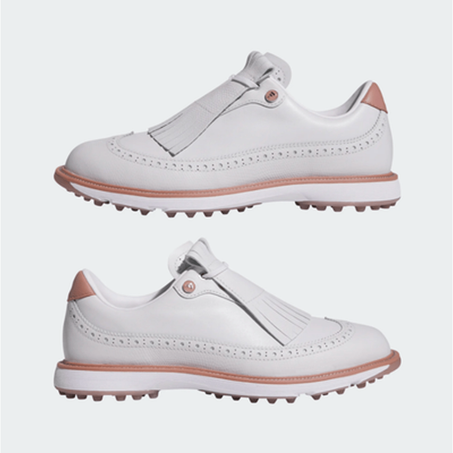 A pair of Adidas MC Zoysia Ladies Spikeless Golf Shoes in grey, styled with decorative perforations and fringe detail on top, featuring BOOST comfort. The shoes are displayed side by side on a plain light background.