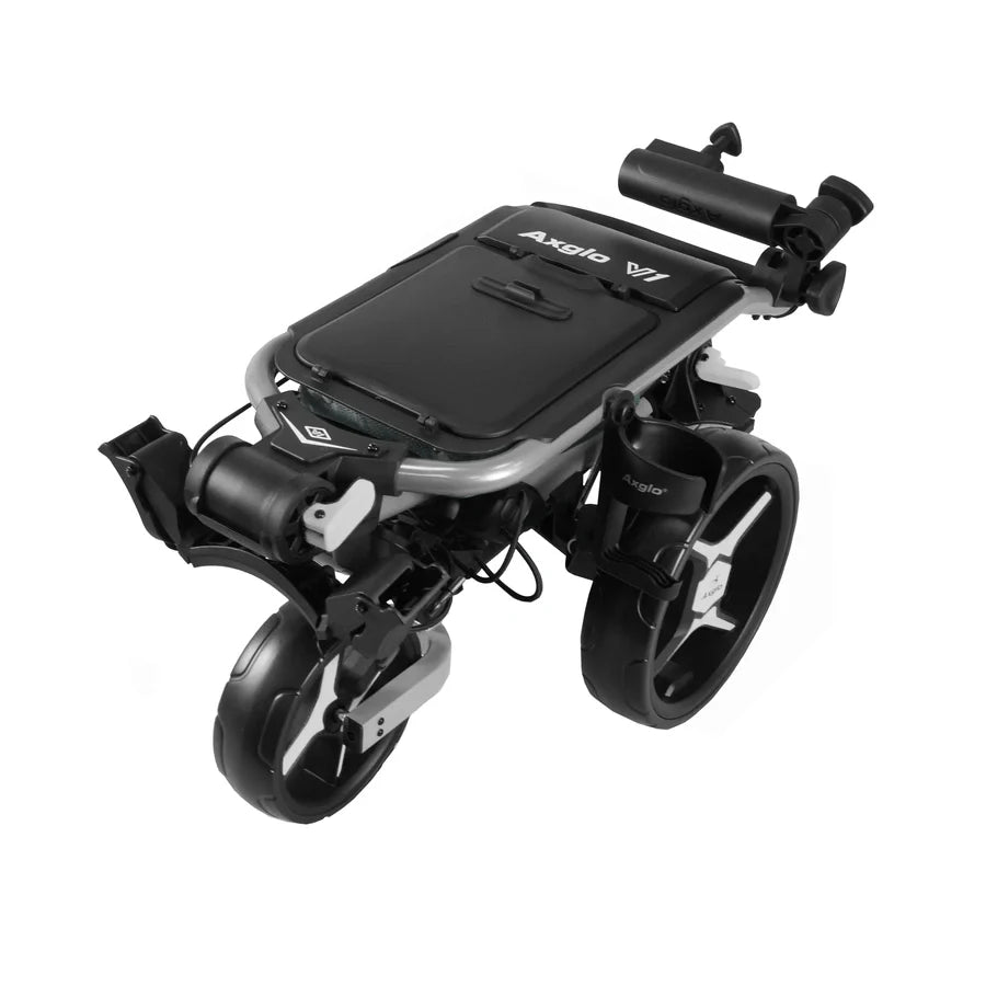 The Axglo V1 Golf Cart is a compact, modern push cart that folds flat for easy transport, featuring a sleek black and silver design, two large rear wheels, and a quick-release wheel system—similar to high-end compact wheelchairs.