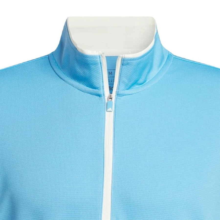 A close-up of the Adidas Lightweight Half-Zip Top in light blue with a white zipper and inner collar, shown from the chest up. This final sale jacket is made from recycled materials and features textured fabric. No person is visible.