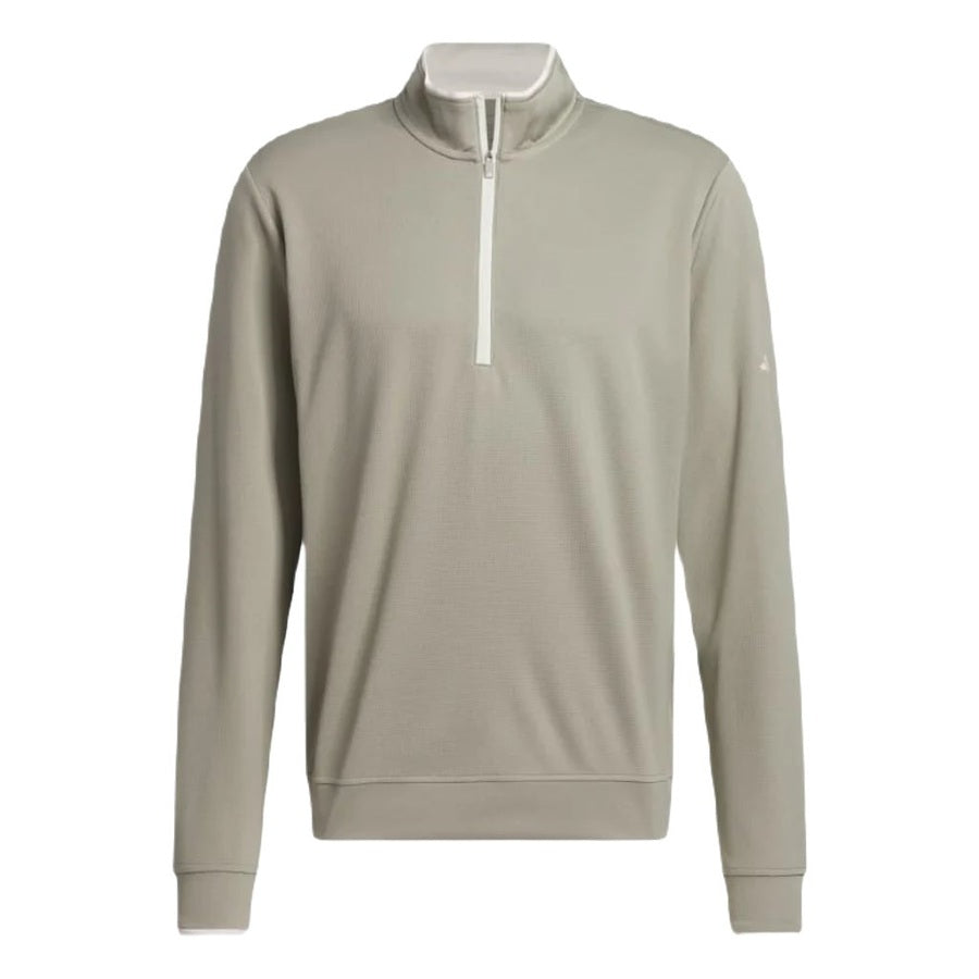 The Adidas Lightweight Half-Zip Top is a light gray, long-sleeve golf pullover with a standing collar and white quarter-zip closure. Made from recycled materials, it features a minimalist design with no visible logos or patterns. Final Sale.