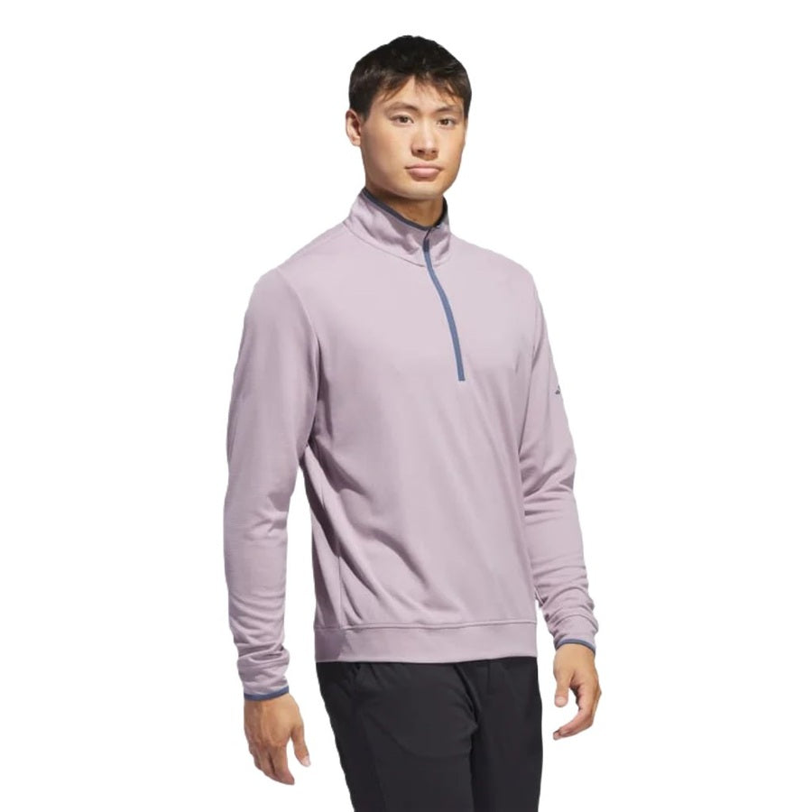 A young man faces forward in a light purple Adidas Lightweight Half-Zip Top - Final Sale, made from recycled materials, paired with black pants against a plain white background.