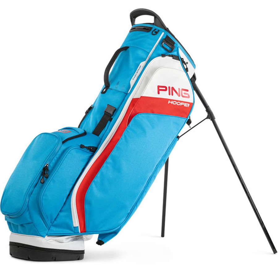 A lightweight Ping Hoofer 231 Golf Carry Bag in blue, white, and red with multiple zippered pockets and an extended built-in stand is shown angled on a white background.