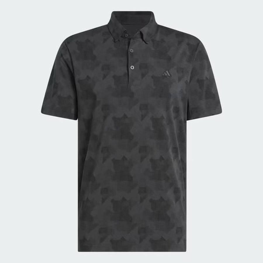 The Adidas 2025 Go-To Printed Polo Shirt is a short-sleeved, dark gray golf polo with a subtle abstract camo print, three-button placket, tonal logo on the left chest, and is made from recycled materials.